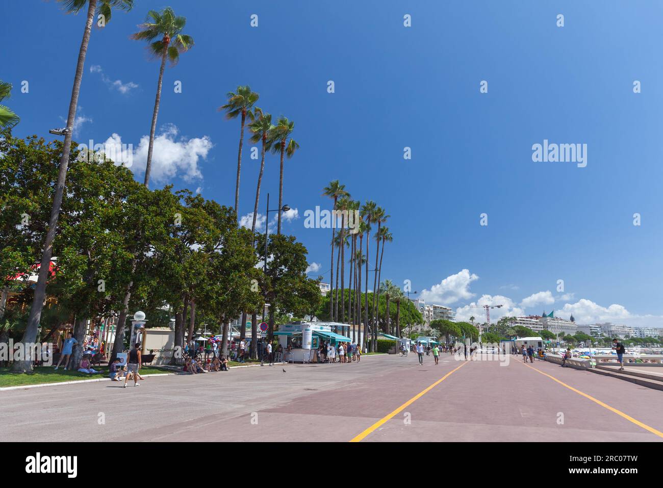 Cannes, France - August 14, 2018: Boulevard de la Croisette, street view with walking people. Cannes on a sunny summer day Stock Photo