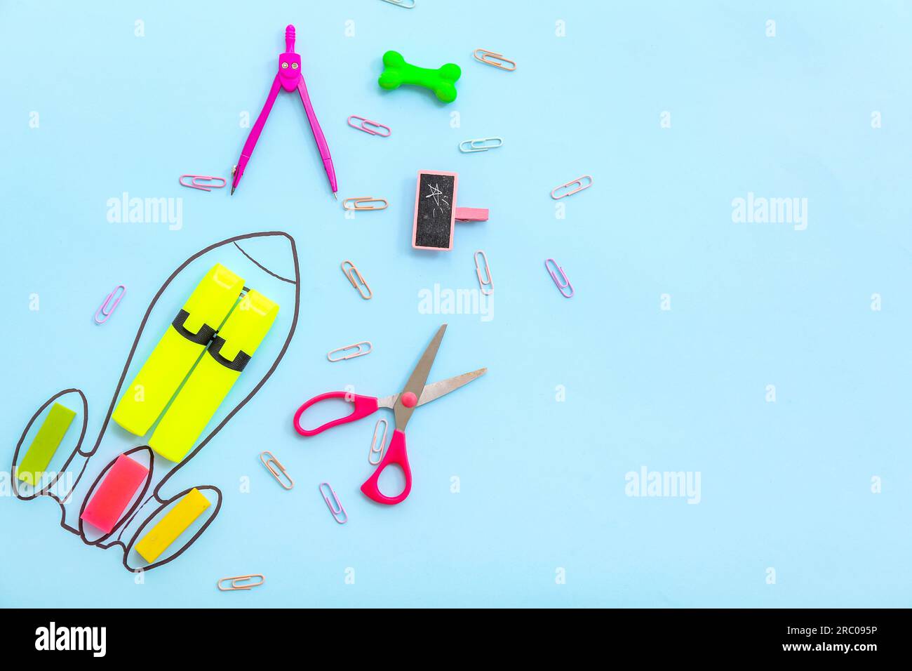 Creative composition with drawn rocket and different stationery on blue background Stock Photo