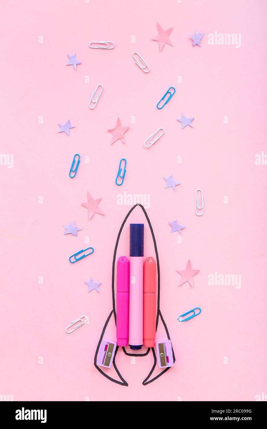 Creative composition with drawn rocket and different stationery on pink background Stock Photo
