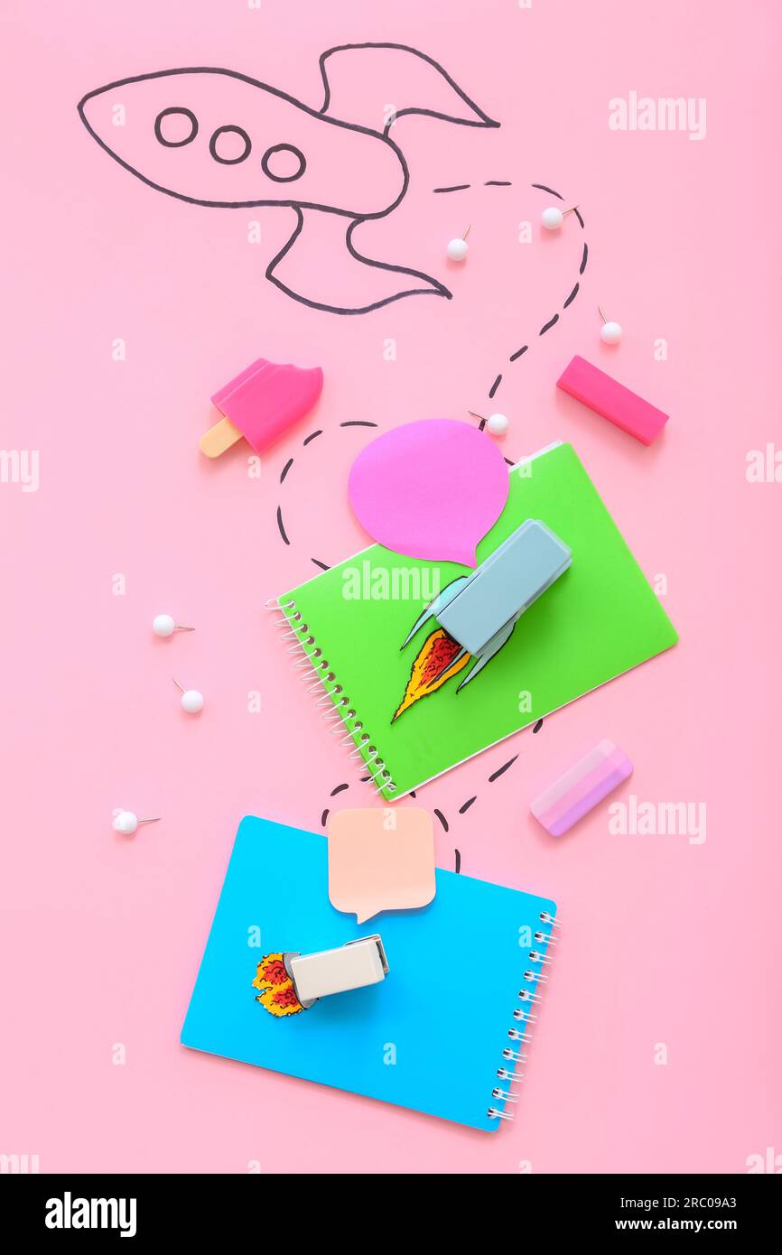 Creative composition with drawn rocket and different stationery on pink background Stock Photo