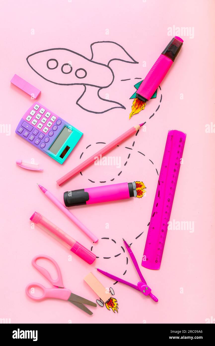 Creative composition with drawn rocket and different stationery on pink background Stock Photo