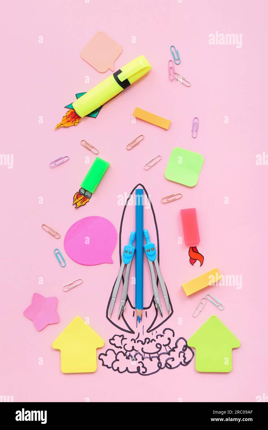 Creative composition with drawn rocket and different stationery on pink background Stock Photo
