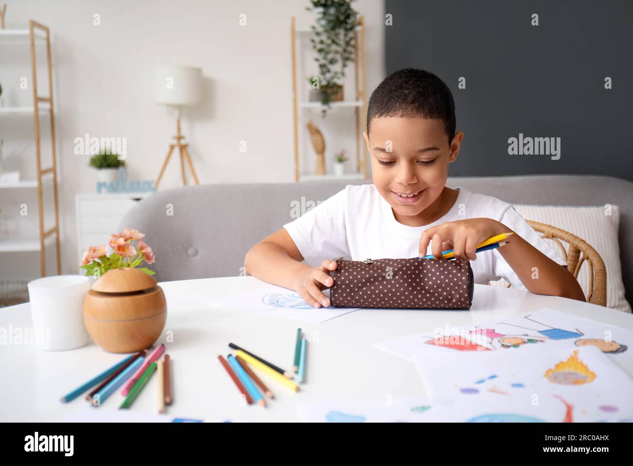 Little African-American boy with pencil case at home Stock Photo - Alamy
