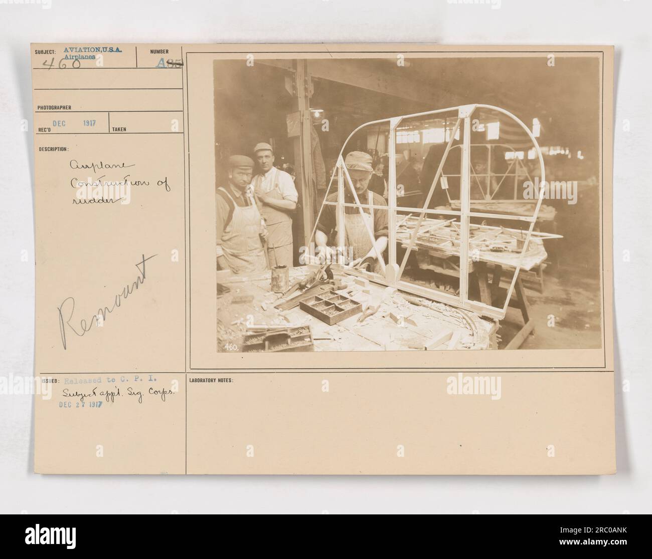 Image of an aviation training session during World War One. The photograph shows the construction of a rudder on an airplane. Taken in December 1917, the image showcases the technical aspects of aircraft manufacturing during the war. Labeled as image number 111-SC-460, it was released to the Committee on Public Information. Stock Photo