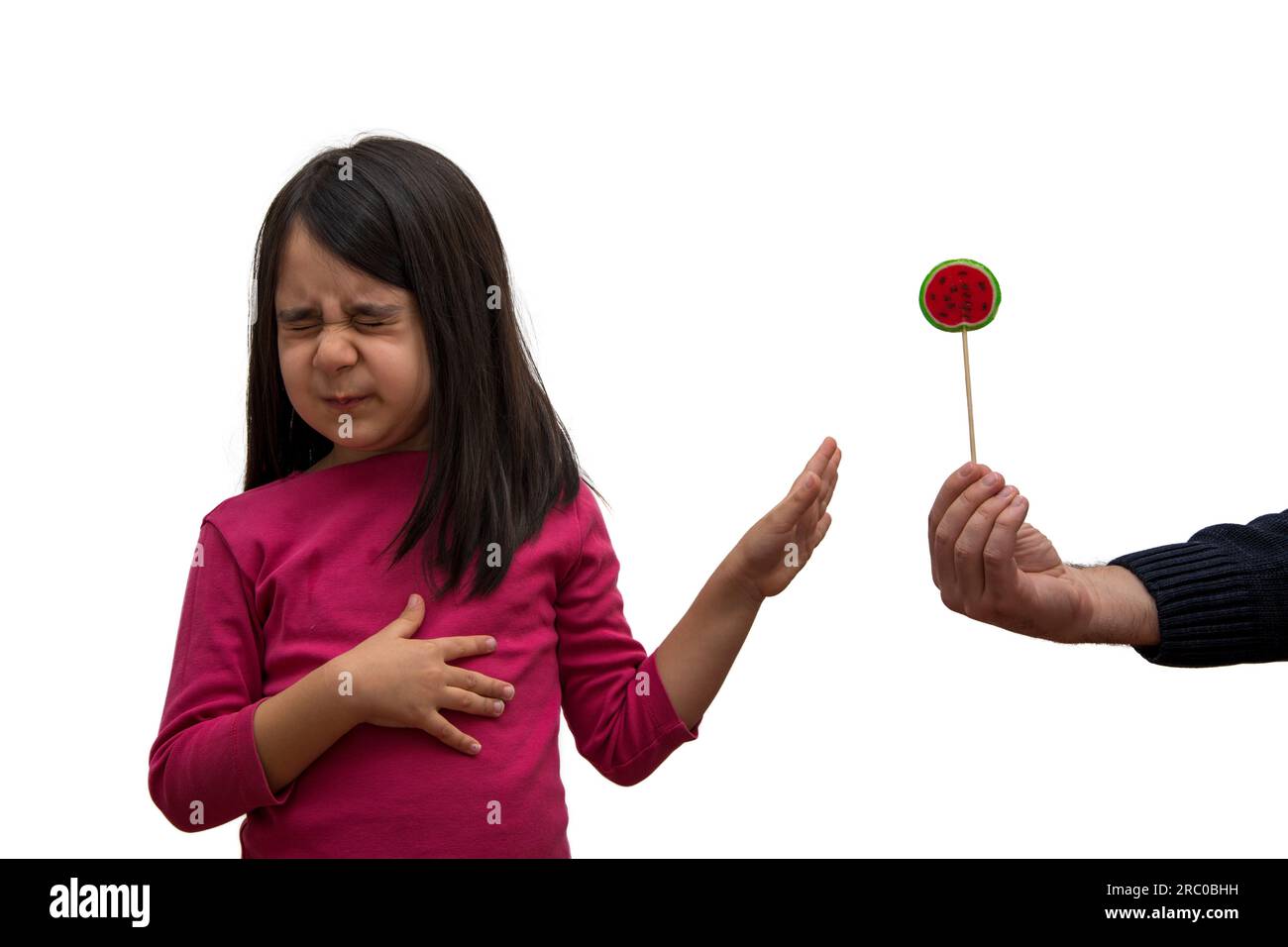 Little girl who doesn't like candy refuses candy offered to her Stock Photo