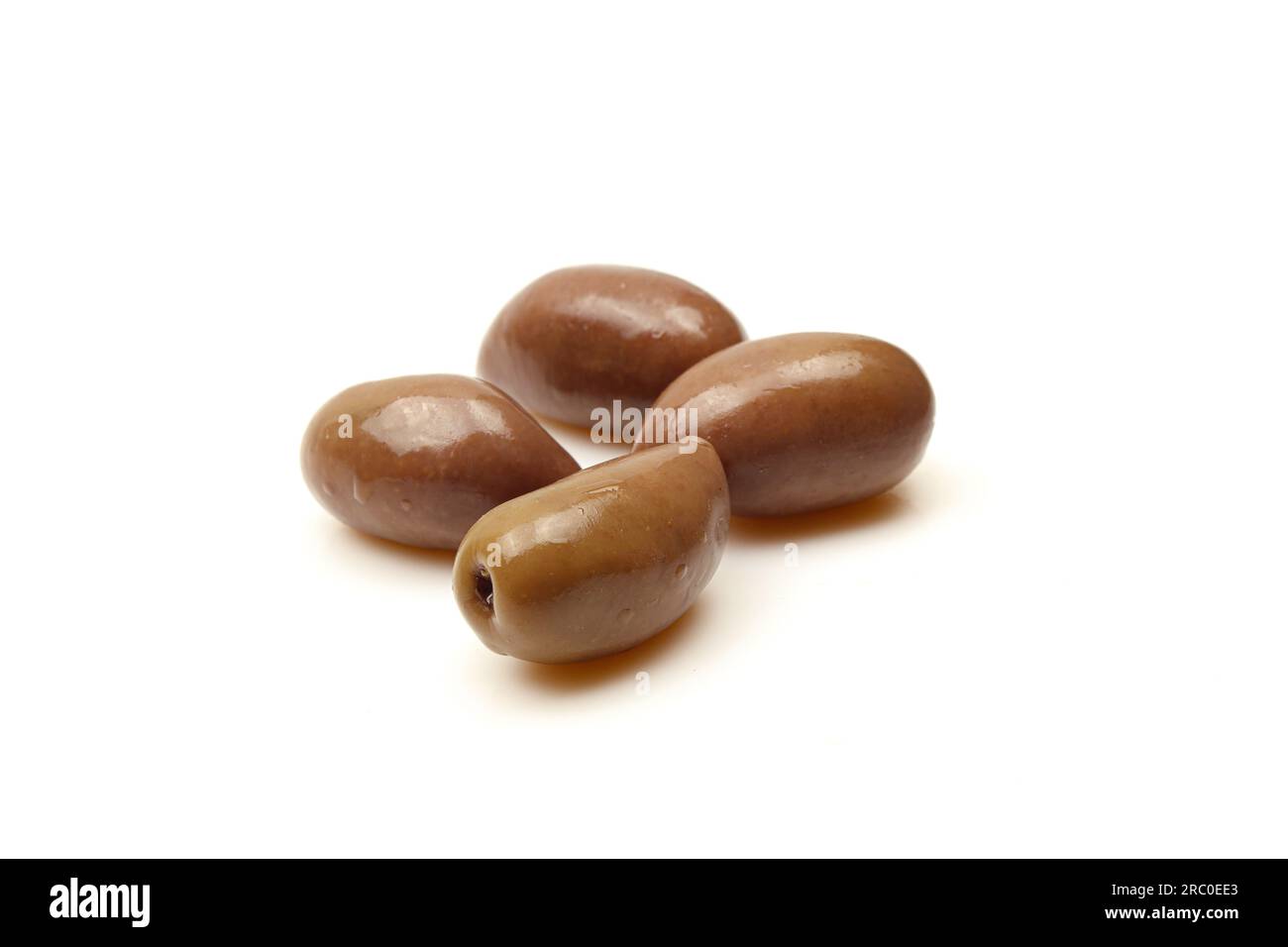Few brown Greek Kalamata olives isolated on white background Stock Photo