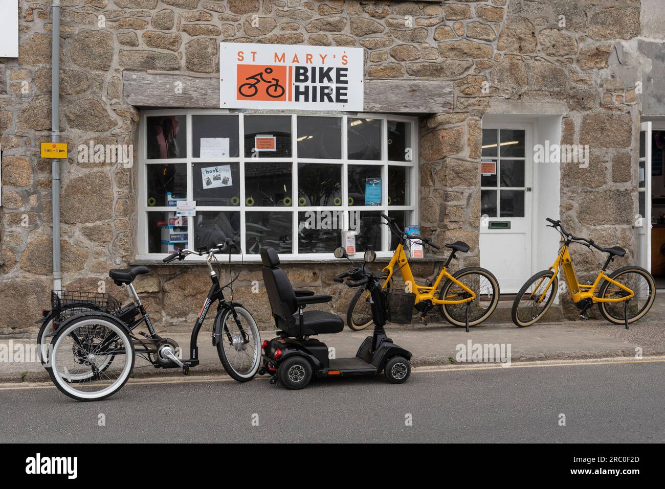 Hugh Town, St Marys, Scilly Islaes, UK. 10 June 2023. Bike and scooter hire shop with an outdoor display in town centre of Hugh Town Stock Photo
