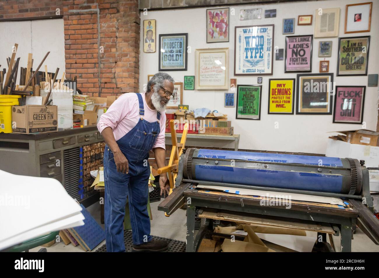 Detroit, Michigan - Amos Kennedy works in his letterpress printing shop. Kennedy prints posters and gives workshops on letterpress printing. Stock Photo