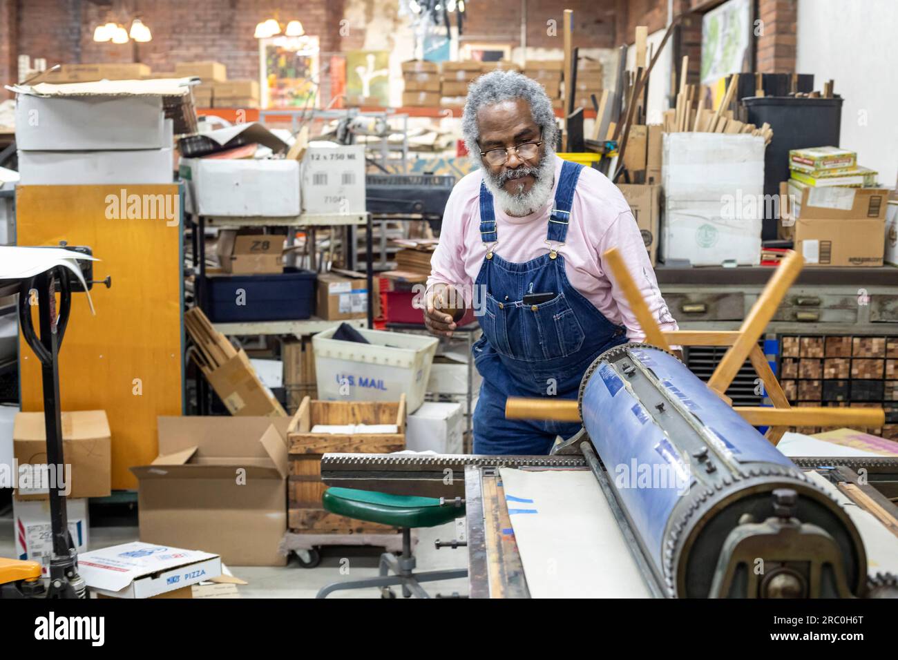 Detroit, Michigan - Amos Kennedy works in his letterpress printing shop. Kennedy prints posters and gives workshops on letterpress printing. Stock Photo