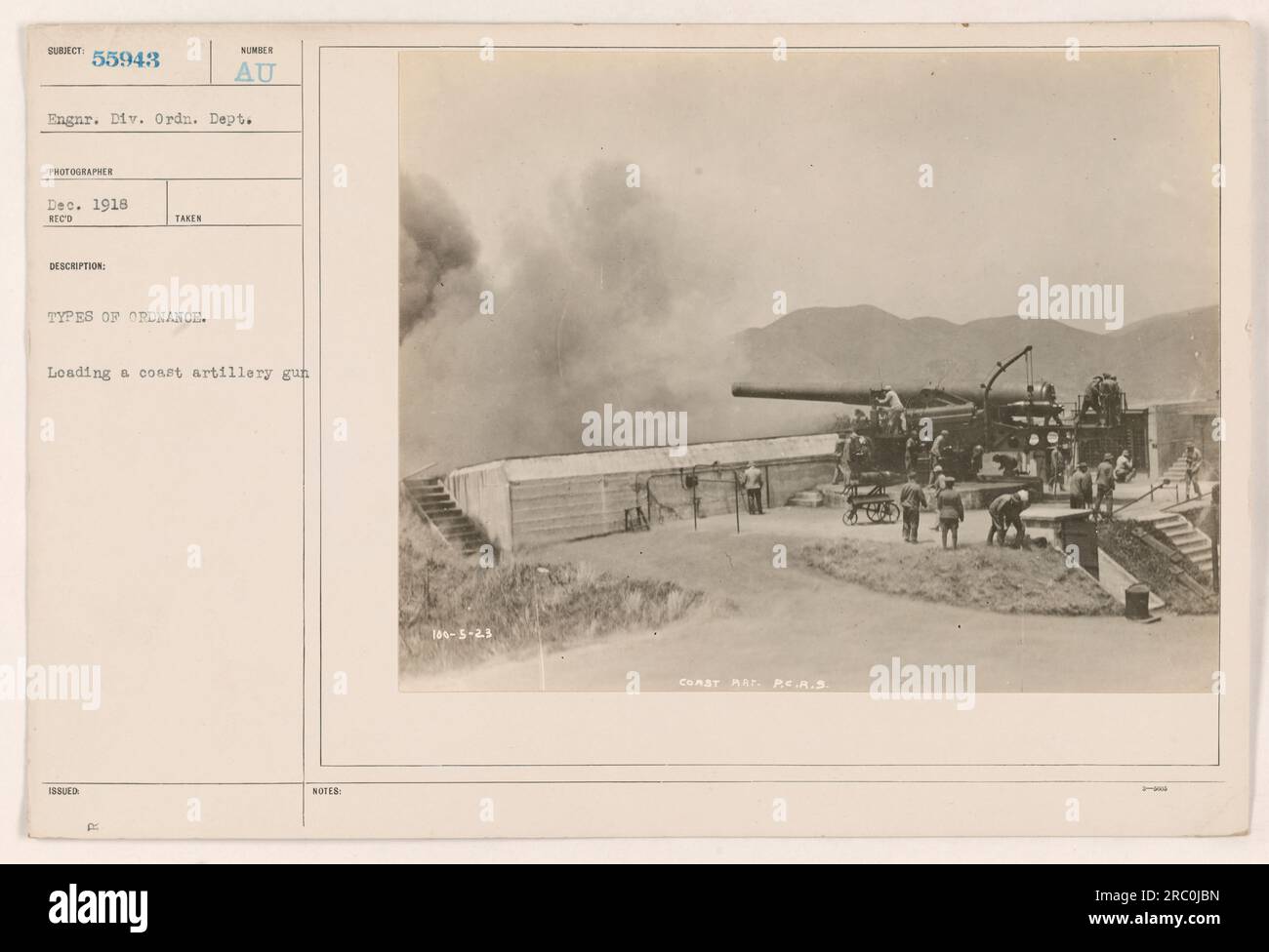 Coast artillery personnel loading a coastal artillery gun during World War One. The photograph was taken by the 55943 Engineer Division of the Ordnance Department in December 1918. The image showcases different types of ordnance being prepared for use. The specific details and identification numbers are also noted: 106-5-23 Coast Rat. PE.A.S. Stock Photo