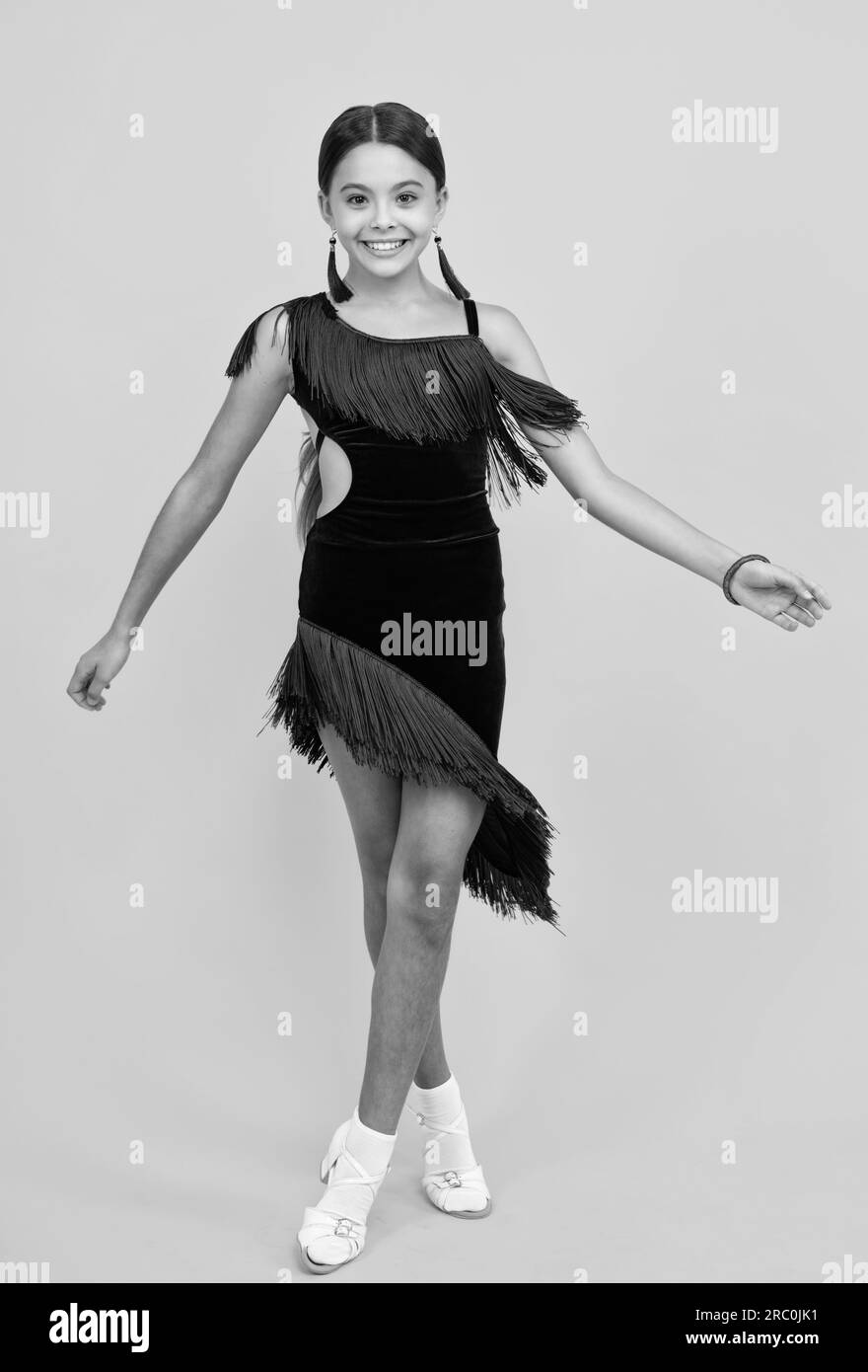 Beauty teenager female dancer is dancing wearing dress. Girl dancing sports ballroom Stock Photo