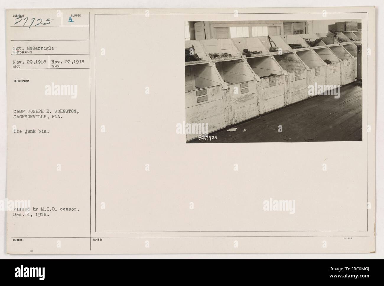 Soldiers sorting through a pile of discarded items at Camp Joseph E ...