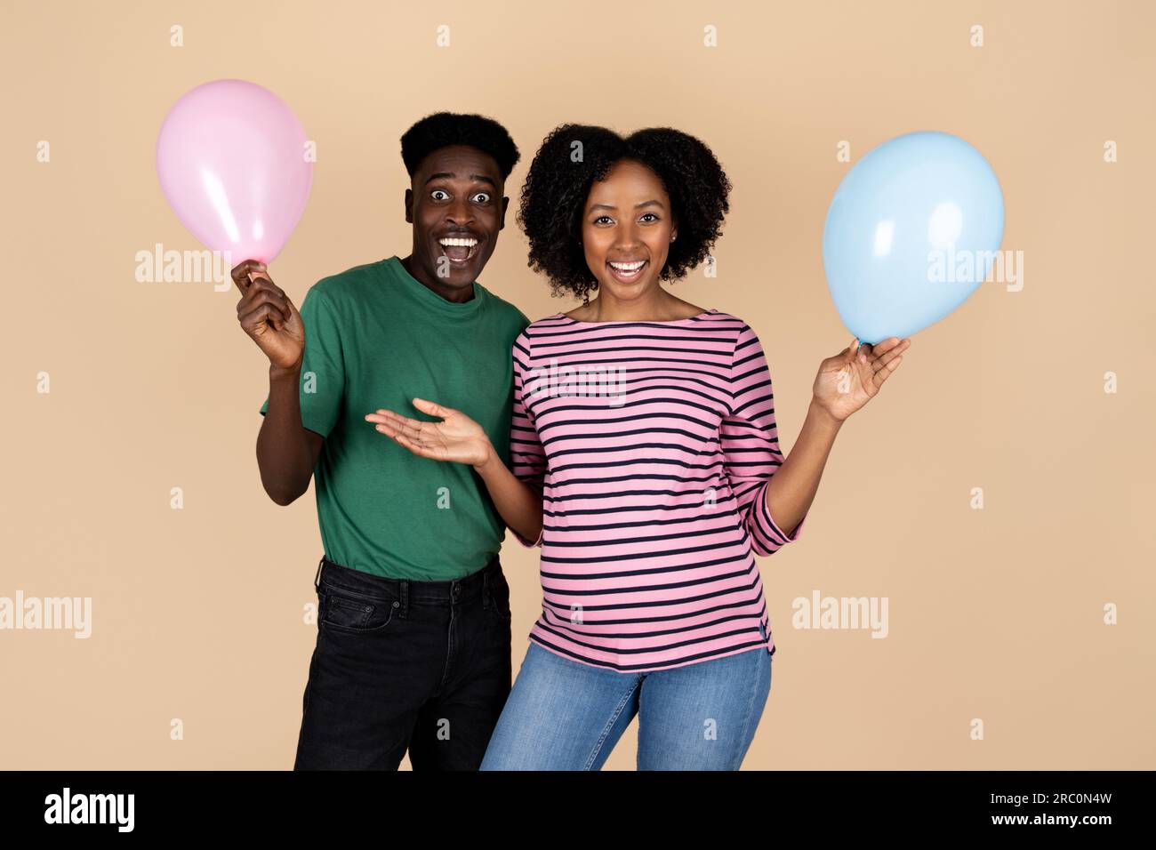 Smiling millennial african american husband and wife with big belly ...