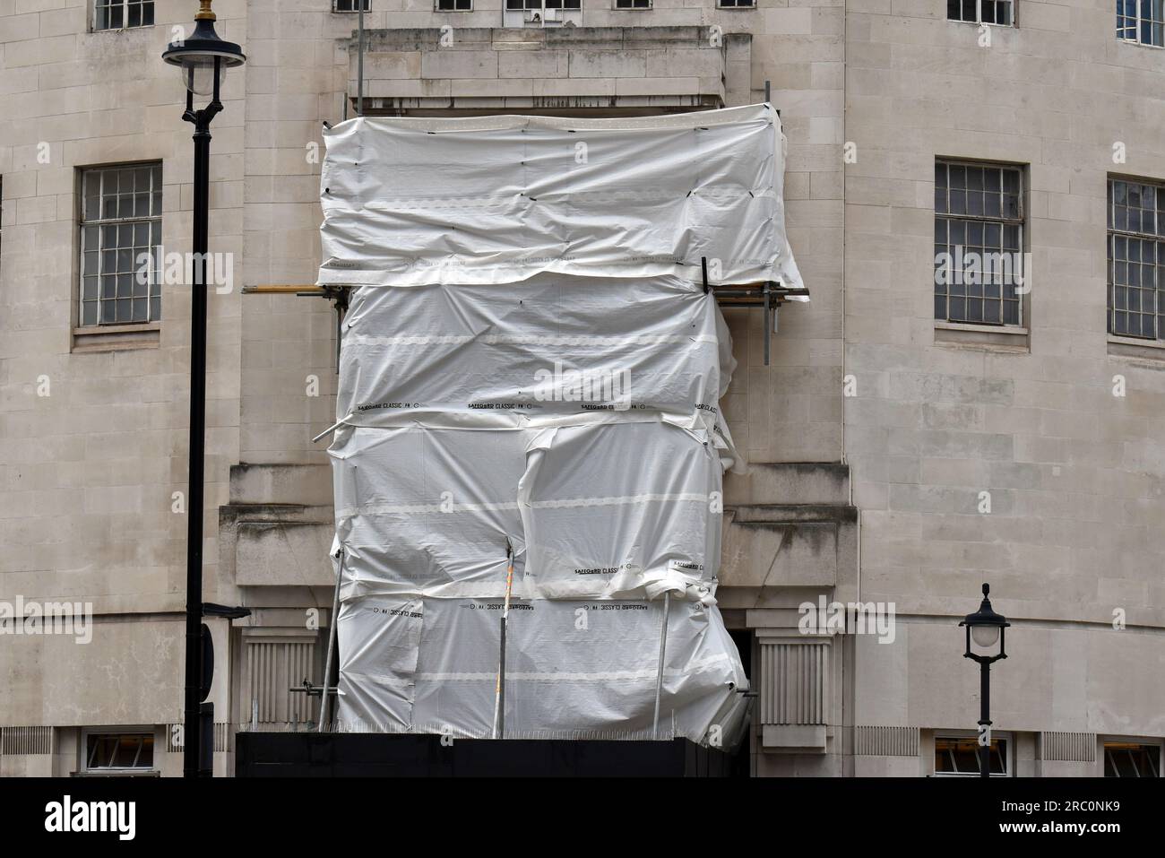 London, UK. 11th July, 2023. Prospero and Ariel statue by Eric Gill under wraps for renovation. BBC headquarters as allegations against unknown presenter are made. Broadcasting House is the headquarters of the BBC, in Portland Place and Langham Place, London. Credit: JOHNNY ARMSTEAD/Alamy Live News Stock Photo