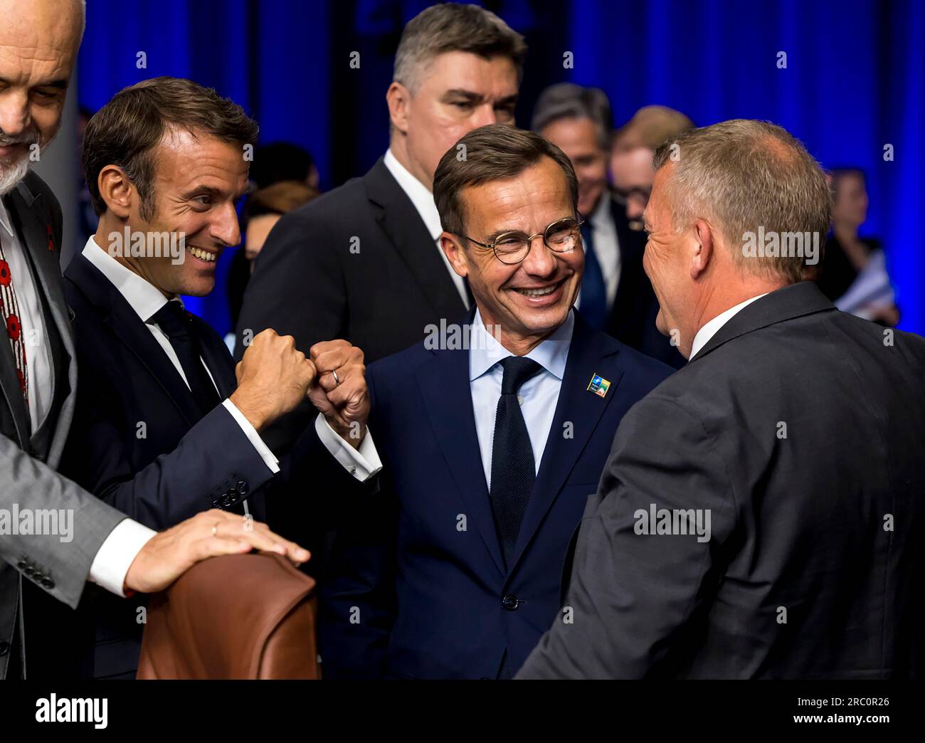 Vilnius, Lithuania. 11th July, 2023. President of France Emmanuel Macron, (L), reacts as he speaks with Swedish Prime Minister Ulf Kristersson (C) and Denmark's Foreign Minister Lars Lokke Rasmussen (R) as they attend the NATO Summit in Vilnius, Lithuania, Tuesday, July 11, 2023. Photo by NATO/ Credit: UPI/Alamy Live News Stock Photo