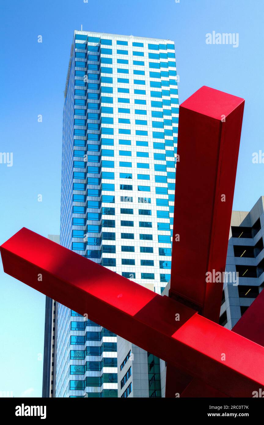 Tampa Cityscape, Big Max painted artistic steel sculpture in foreground with skyscaper in background. Sculpture is a partial view of steel beam struct Stock Photo