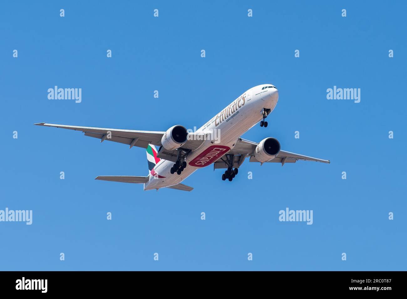 Lisbon, Portugal - July 12, 2023: UAE based air company Emirates with aircraft Boeing 777-300ER approaching to land at Lisbon International Airport Stock Photo