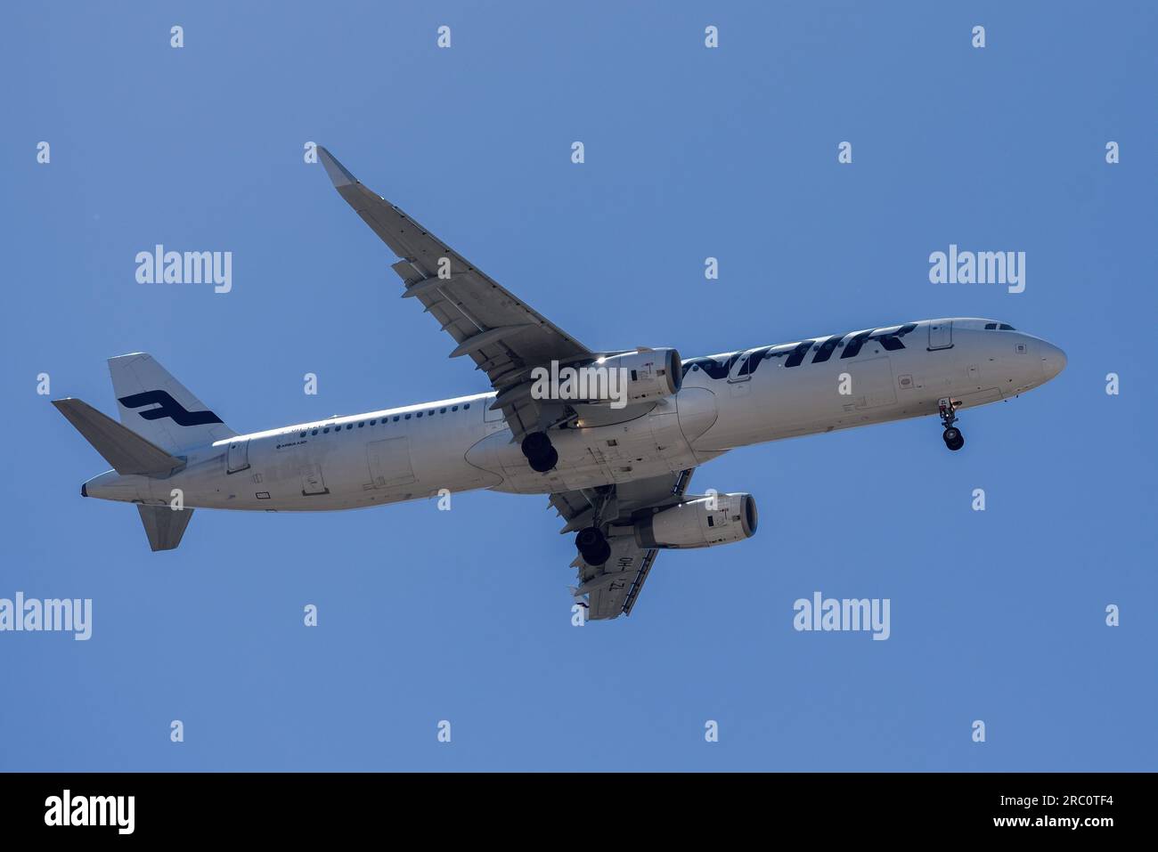 Lisbon, Portugal - July 12, 2023: Finnish Airways with aircraft Airbus A321 approaching to land at Lisbon International Airport against blue sky Stock Photo