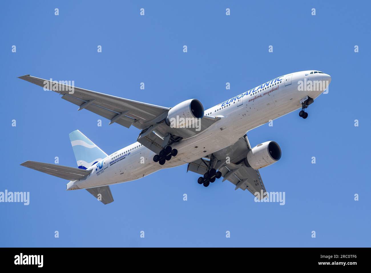 Lisbon, Portugal - July 12, 2023: Portuguese air company Euroatlantic with aircraft Boeing 777-200ER approaching to land at Lisbon International Stock Photo