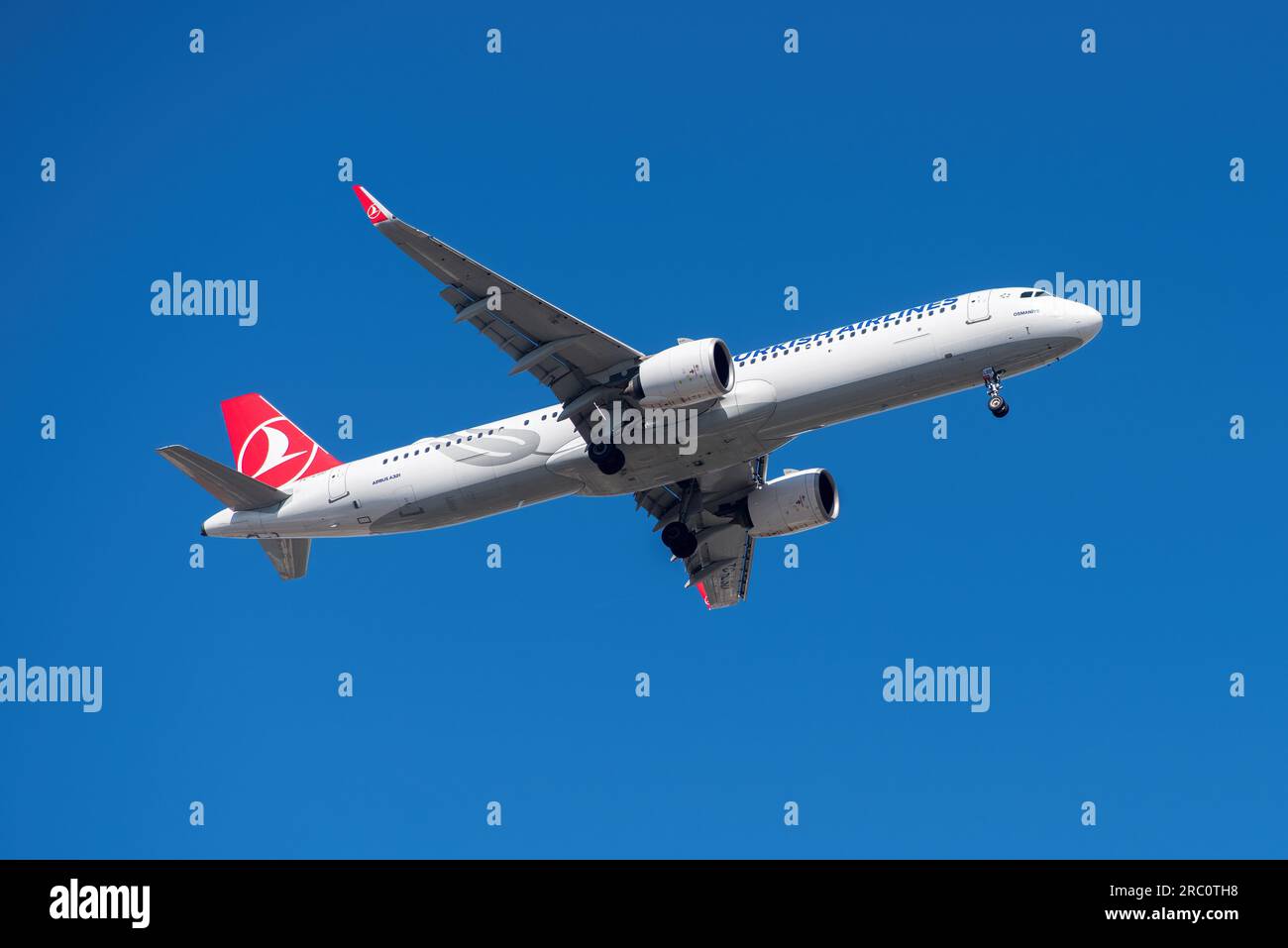 Lisbon, Portugal - July 12, 2023: Turkish Airlines with aircraft Airbus A321 approaching to land at Lisbon International Airport against blue sky Stock Photo