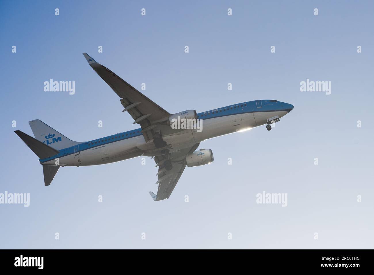 Lisbon, Portugal - July 12, 2023: Dutch company KLM with aircraft Boeing 737-8K2 approaching to land at Lisbon International Airport against blue sky Stock Photo