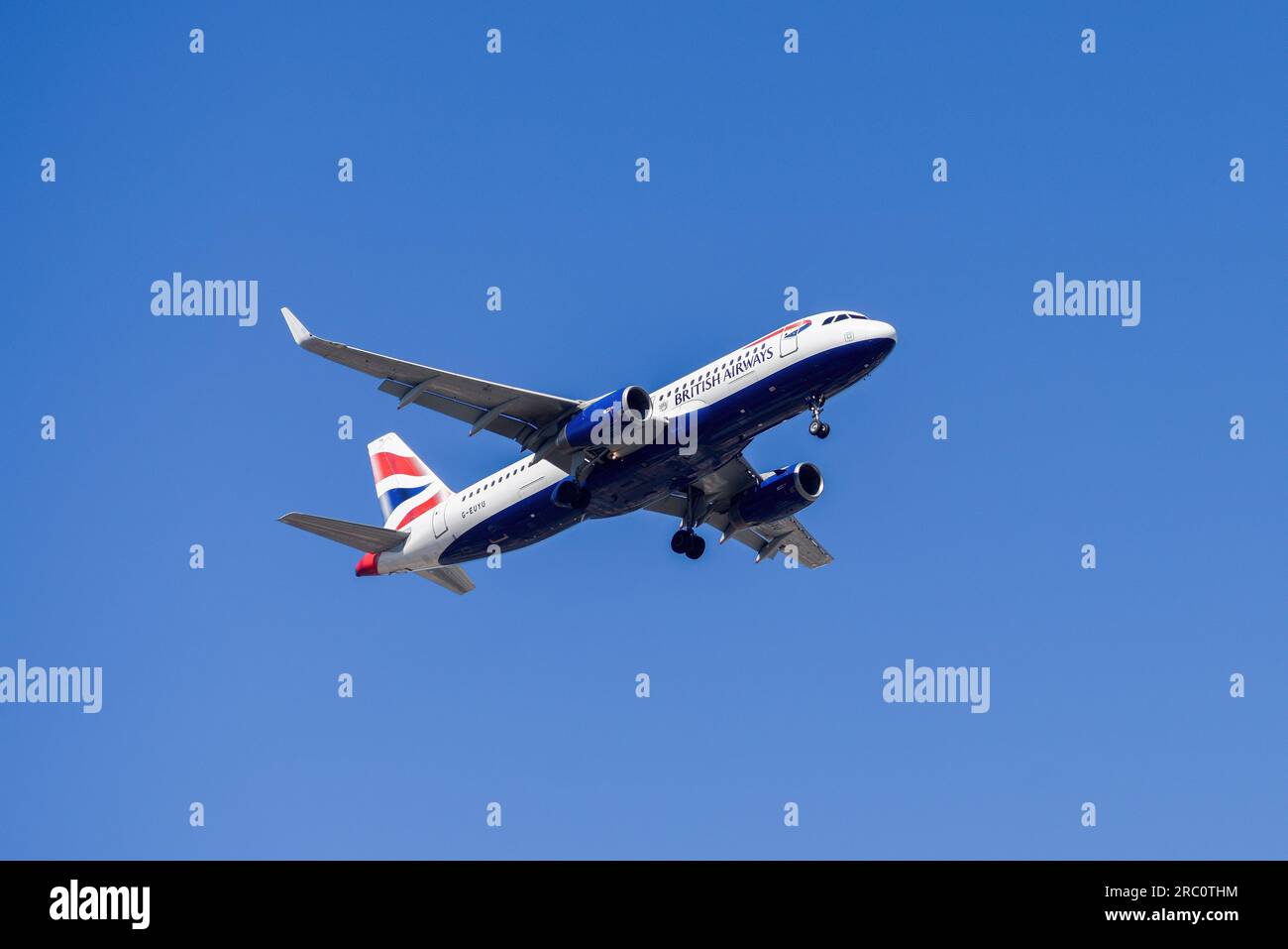 Lisbon, Portugal - July 12, 2023: British Airways with aircraft Airbus A320-232 approaching to land at Lisbon International Airport against blue sky Stock Photo