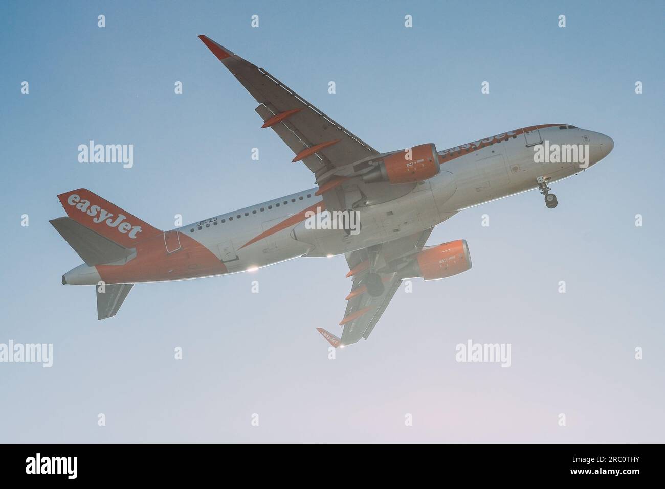 Lisbon, Portugal - July 12, 2023: Low cost air company Easyjet with aircraft Airbus A320-214 approaching to land at Lisbon International Airport Stock Photo