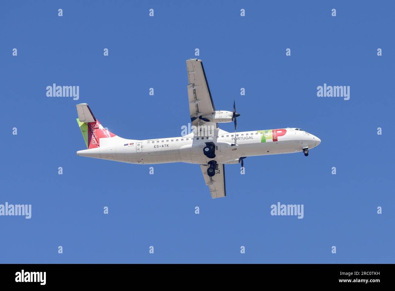 Lisbon, Portugal - July 12, 2023: Portuguese company Tap with aircraft ATR 72-600 approaching to land at Lisbon International Airport against blue sky Stock Photo