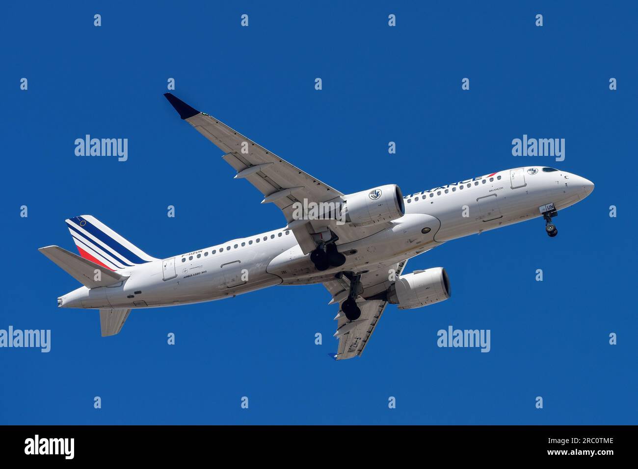 Lisbon, Portugal - July 12, 2023: Air France with aircraft Airbus A220-300 approaching to land at Lisbon International Airport against blue sky Stock Photo