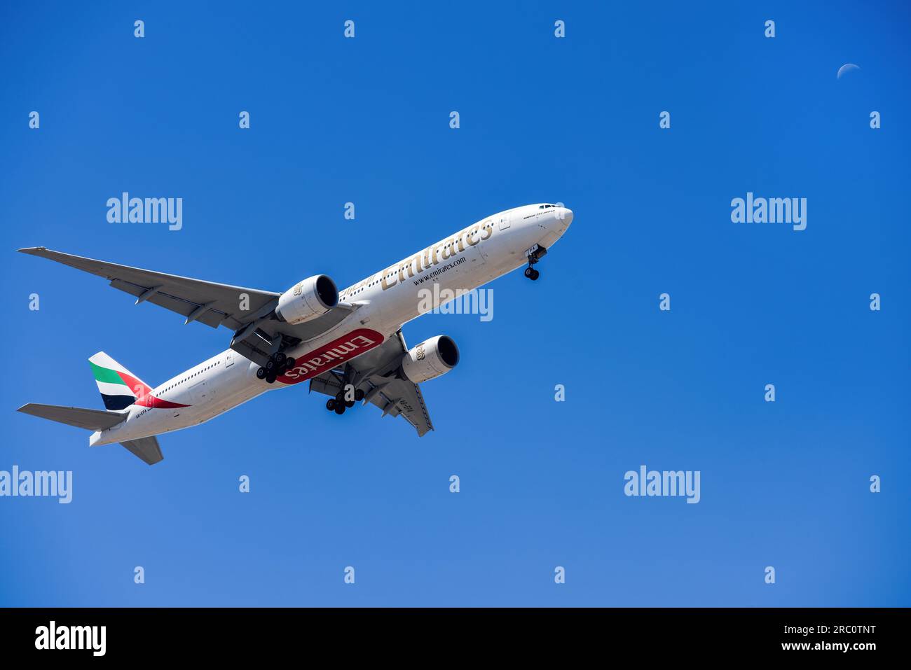 Lisbon, Portugal - July 12, 2023: UAE based air company Emirates with aircraft Boeing 777-300ER approaching to land at Lisbon International Airport Stock Photo