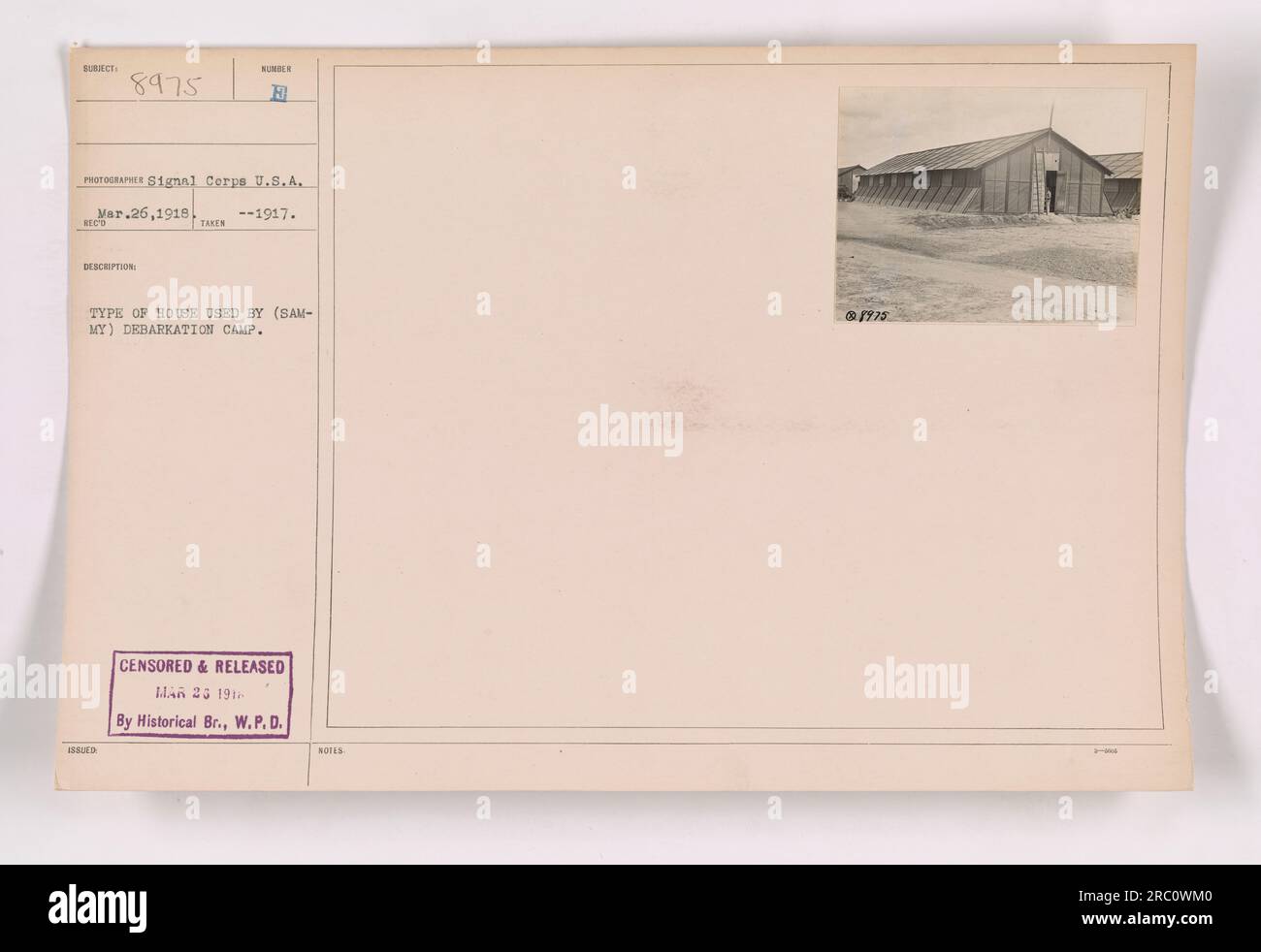 This photograph shows a type of house used by the debarkation camp SUBIECT 8975 during World War One. The house appears to be made of wood and has a simple design. The image was taken in 1917 by a photographer from the Signal Corps U.S.A. It was censored and released on March 23, 1918, by the Historical Branch, W.P.D. Numbered as 111-SC-8975. Stock Photo