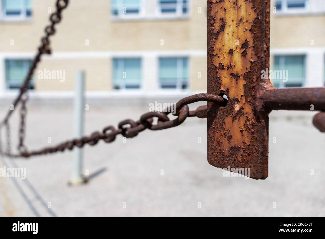 Rusted metal chain fence gate - blurred background. Taken in Toronto, Canada. Stock Photo