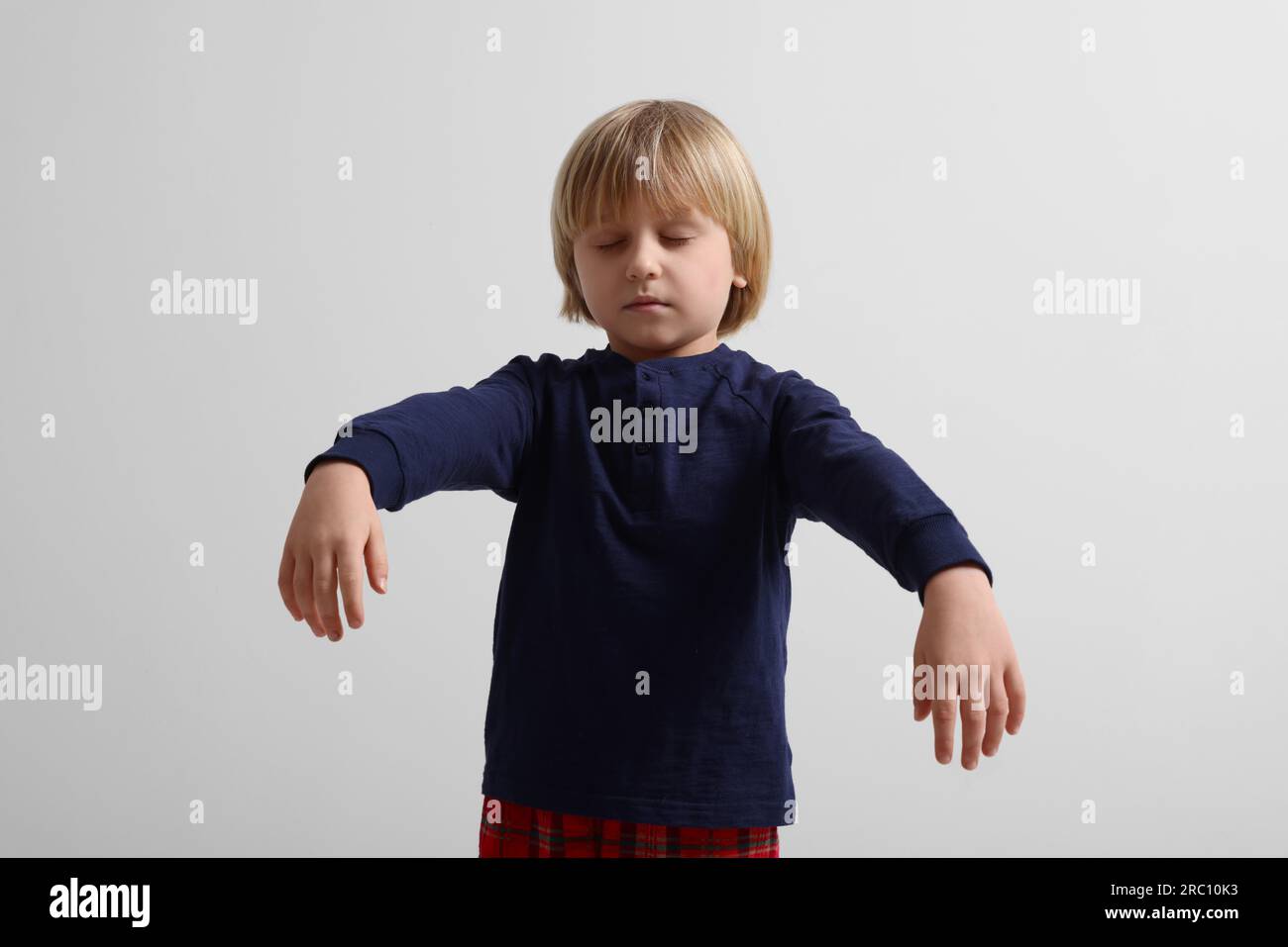 Boy in pajamas sleepwalking on white background Stock Photo Alamy