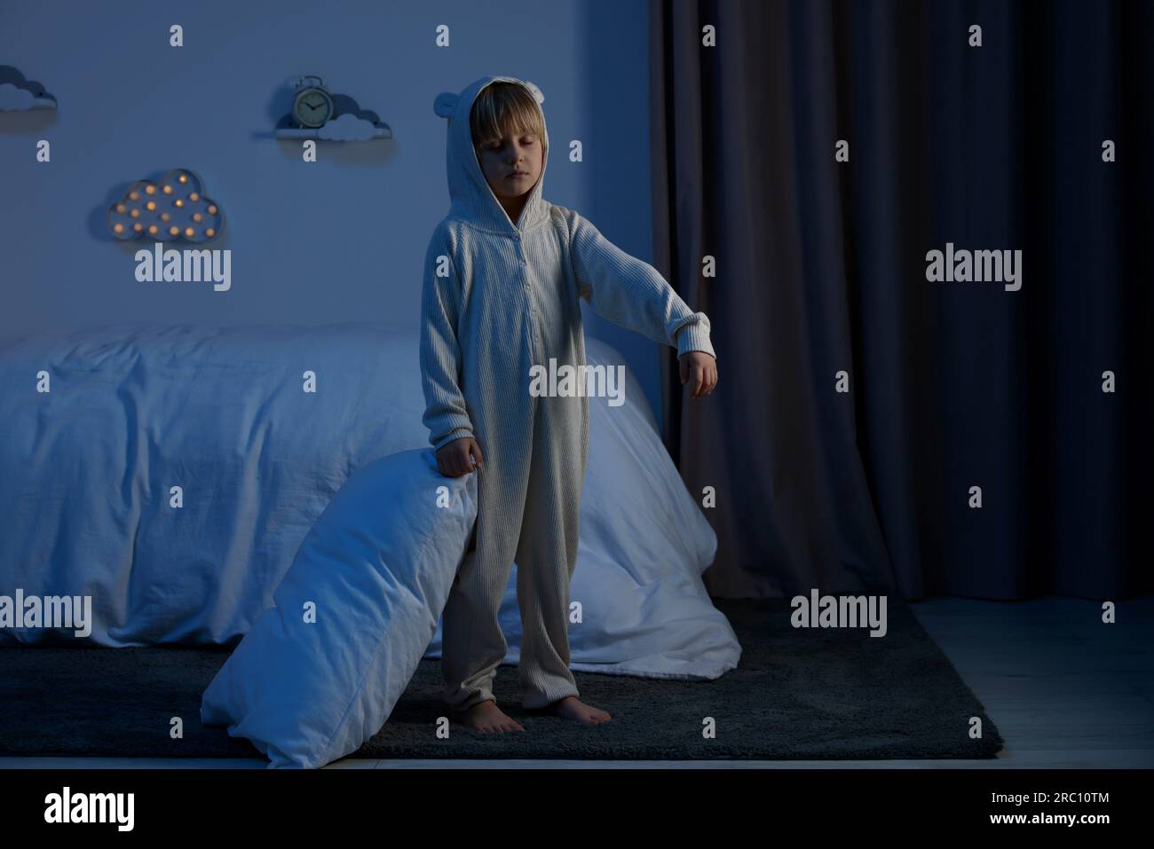 Boy in pajamas sleepwalking indoors at night Stock Photo Alamy