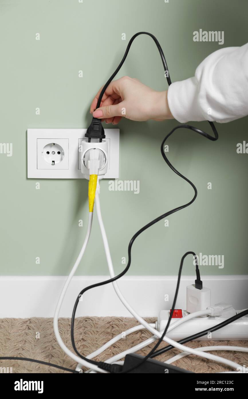 Hand putting plug electricity socket hi-res stock photography and ...
