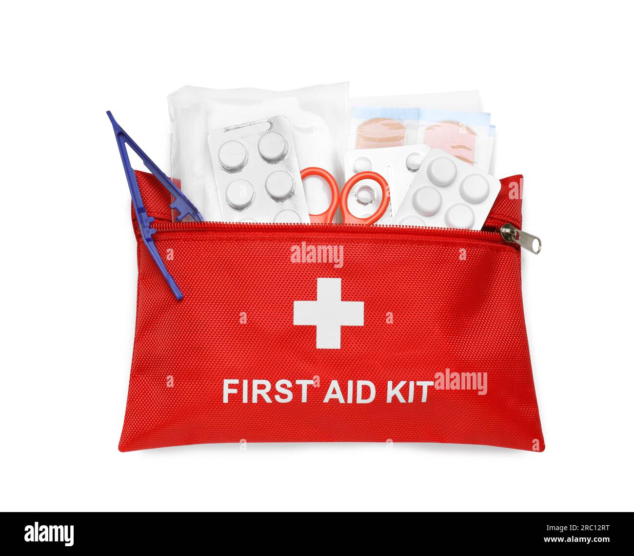 Red first aid kit with scissors, pills, plastic forceps and medical