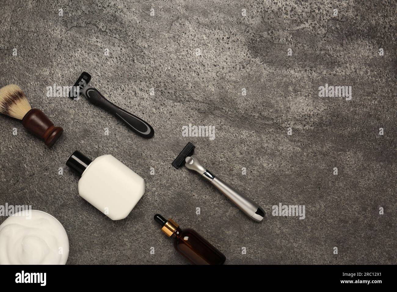 Flat lay composition with shaving accessories for men on grey table ...
