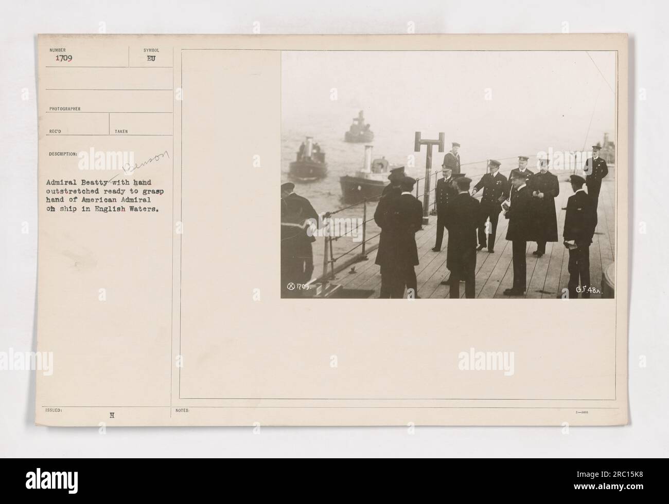 Admiral Benson leaves the British flagship as Admiral Beatty offers a handshake in English waters during World War One. The photo captures a historic moment of cooperation between American and British naval forces. Admiral H. Benson's presence highlights the collaboration between the two allies during the conflict. Stock Photo