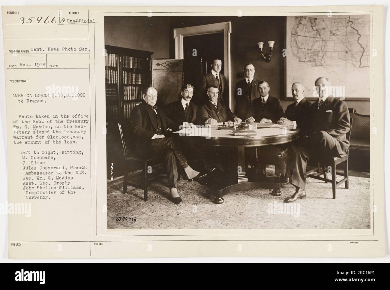 Caption: 'Photograph taken in February 1918, showing the office of the Secretary of the Treasury Wm. G. McAdoo. Secretary McAdoo is seen signing a Treasury warrant for a $100,000,000 loan to France. Also present in the photograph are M. Coesnare, J. Simon 18 SUED Jules Jusserand, French Ambassador to the U.S., Assistant Secretary Crosby, and John Skelton Williams, Comptroller of the Currency.' Stock Photo