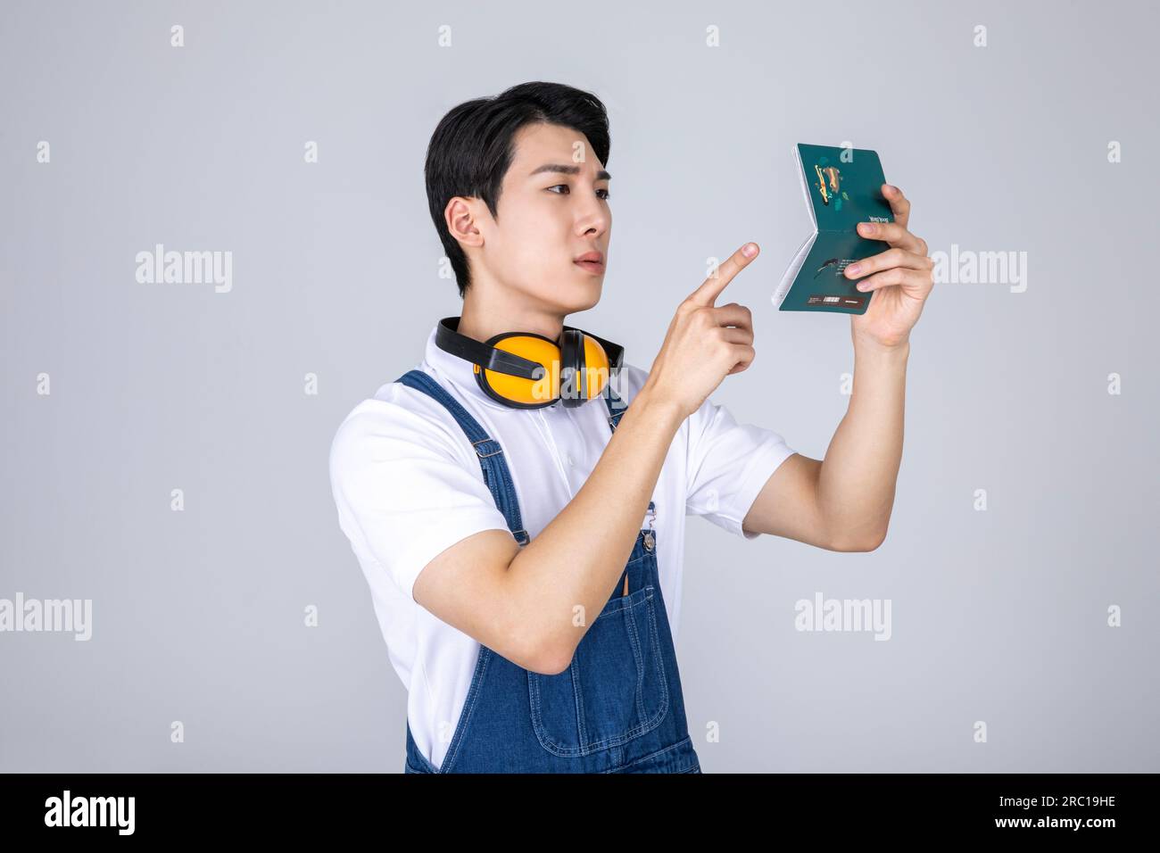 millennials and gen z, korean asian young man carpenter holding a bankbook Stock Photo