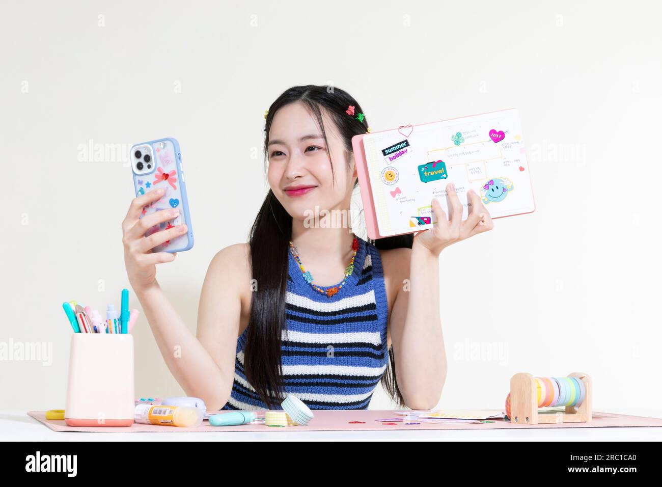 vintage y2k retro concept photo of korean asian cute woman taking selfie of diary decoration with smartphone Stock Photo