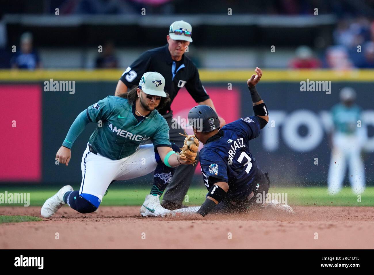 American League's Bo Bichette, of the Toronto Blue Jays, puts down his  glove in between innings during the MLB All-Star baseball game against the  National League in Seattle, Tuesday, July 11, 2023. (