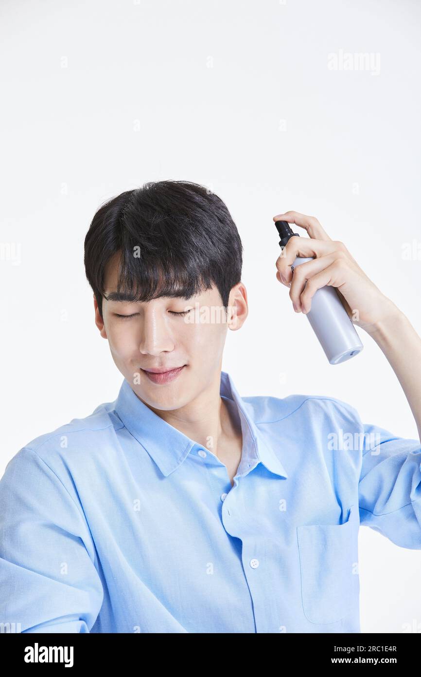 korean asian young man using hairspray Stock Photo Alamy