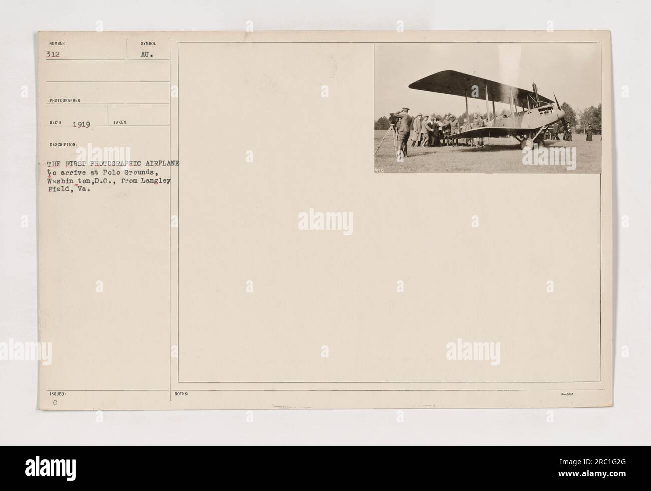 The first photographic airplane to arrive at Polo Grounds, Washington, D.C. from Langley Field, VA. The photo was taken in 1919 by Hoed. The airplane, designated as Number 312, had the symbol 'AU' and is seen in the image. The caption also includes a note stating that this was the first photographic airplane to arrive at Polo Grounds. Stock Photo