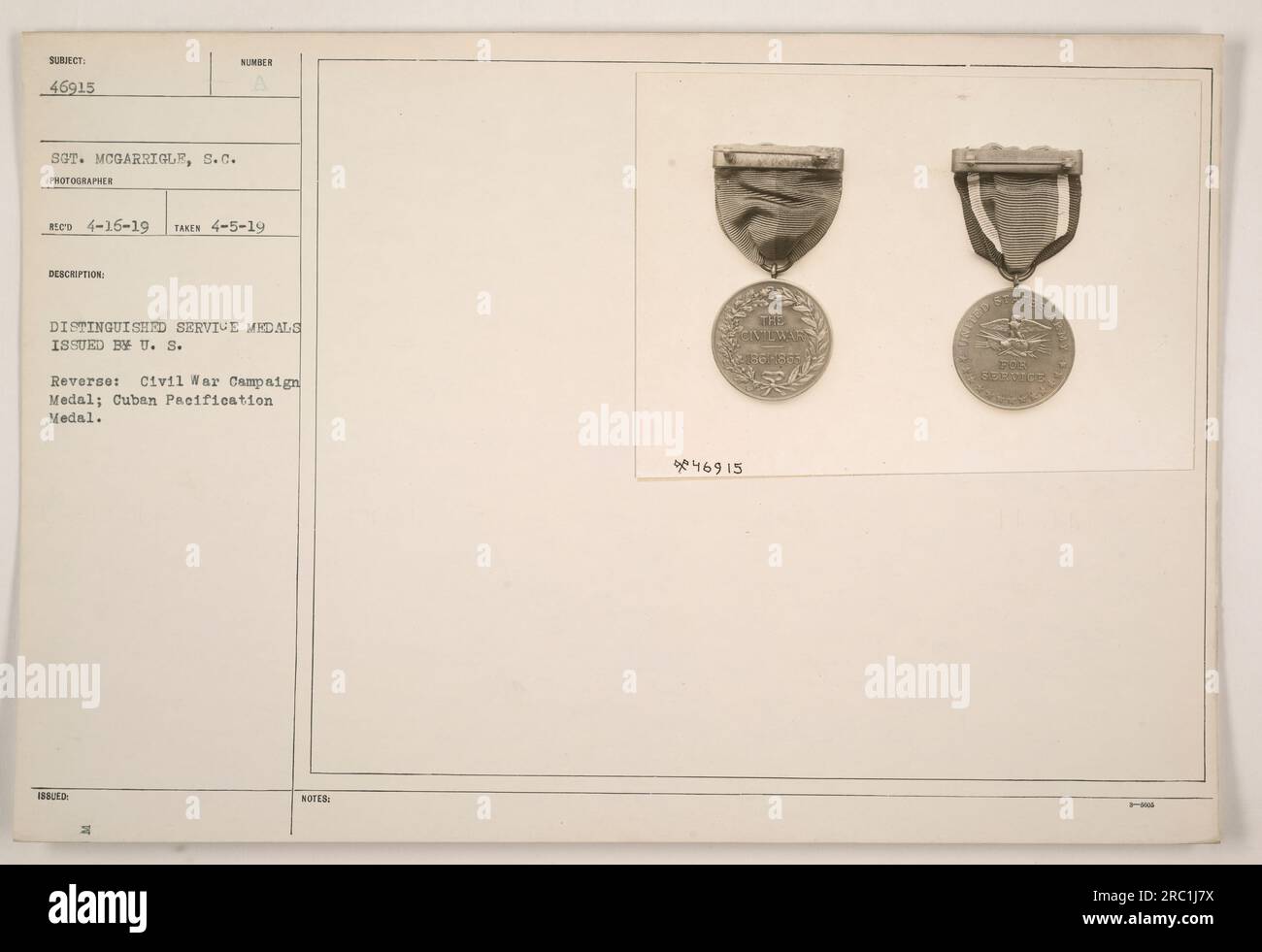 In this photograph, Distinguished Service Medals issued by the U.S. are displayed. The reverse side shows a Civil War Campaign Medal and a Cuban Pacification Medal. There is a label that reads 'SOT. MCGARRIGLE, S.C. PHOTOGRAPHES RECO 4-16-19 TAKEN 4-5-19.' These medals are a recognition of the recipient's distinguished service in various military operations, including the Civil War campaign and the Cuban pacification. Stock Photo