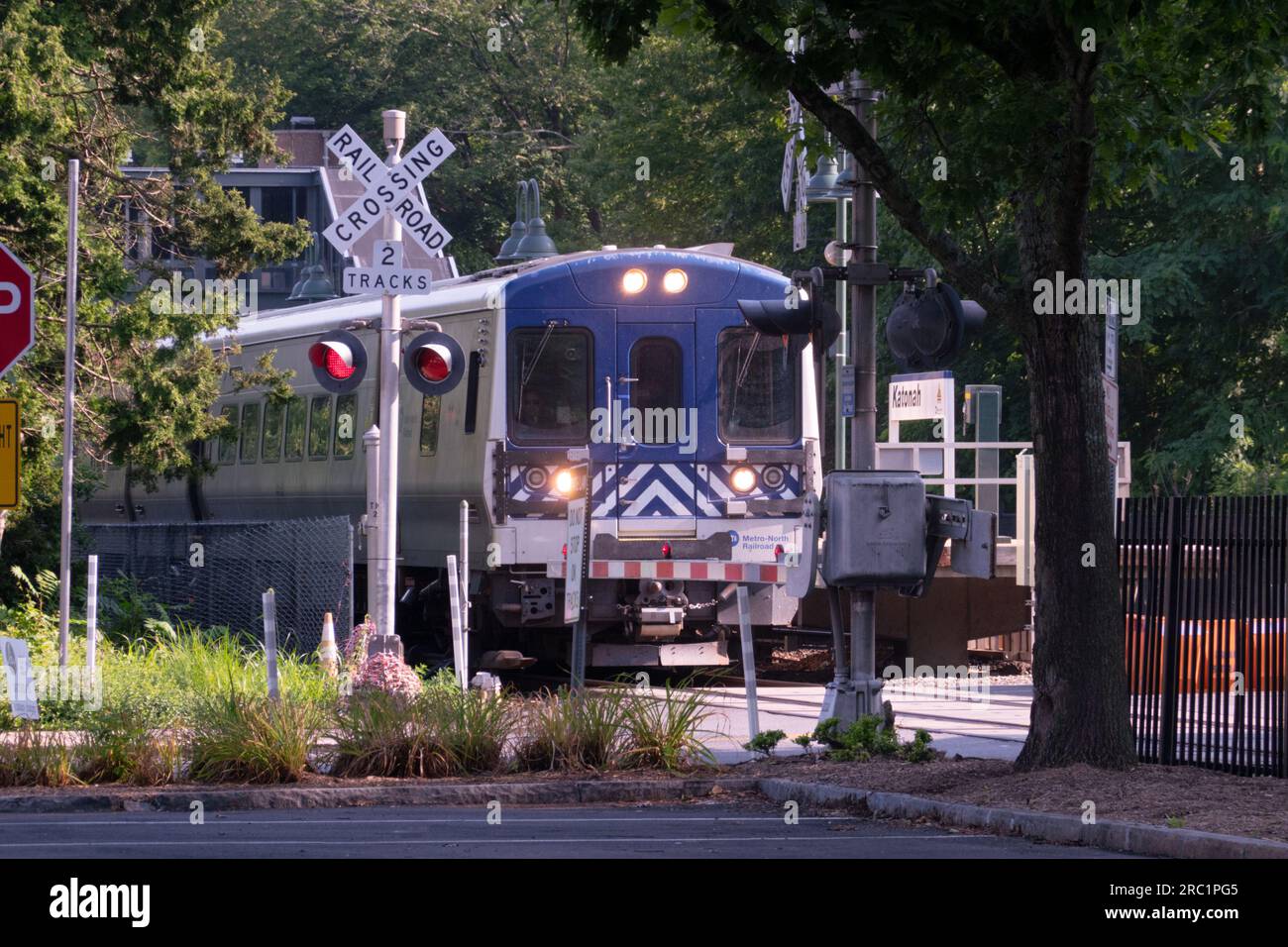 A Metro North train leaves the Katonah station, crossing Jay St then