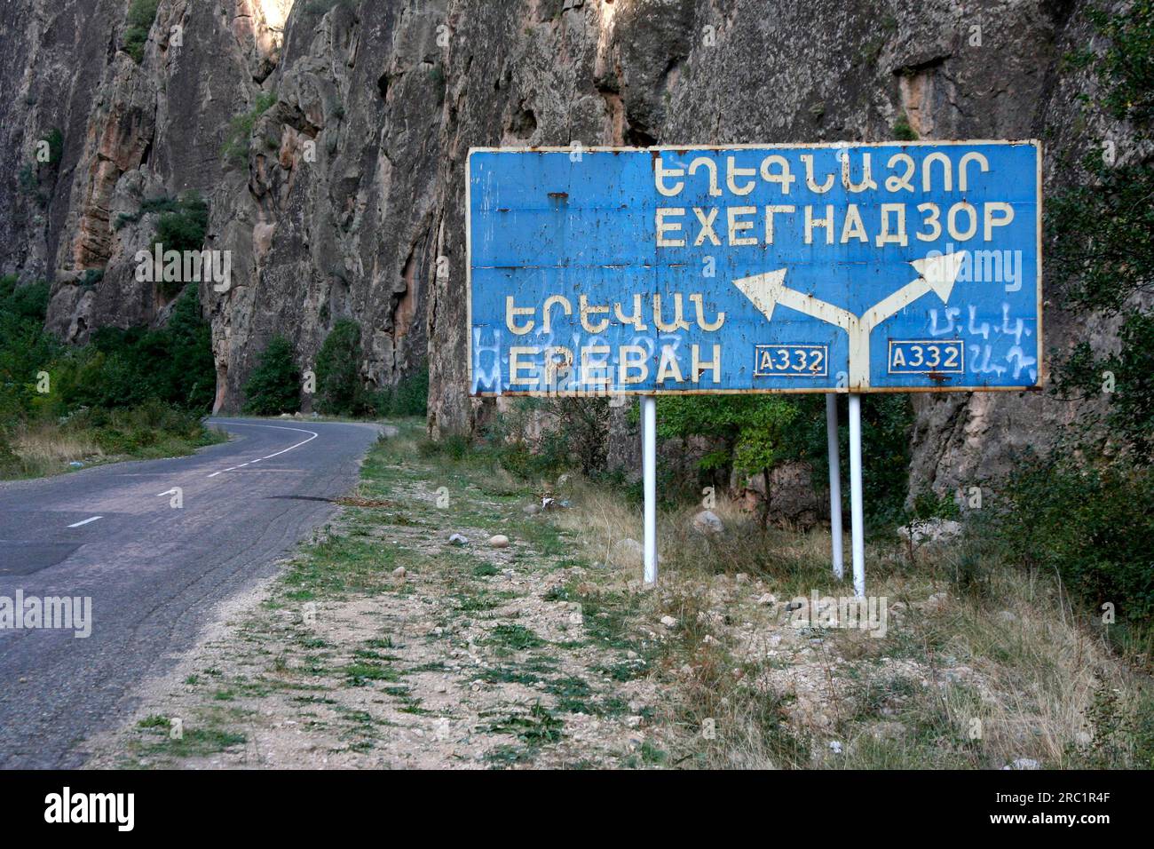 A dilapidated street sign in Armenian and Cyrillic script, Armenia