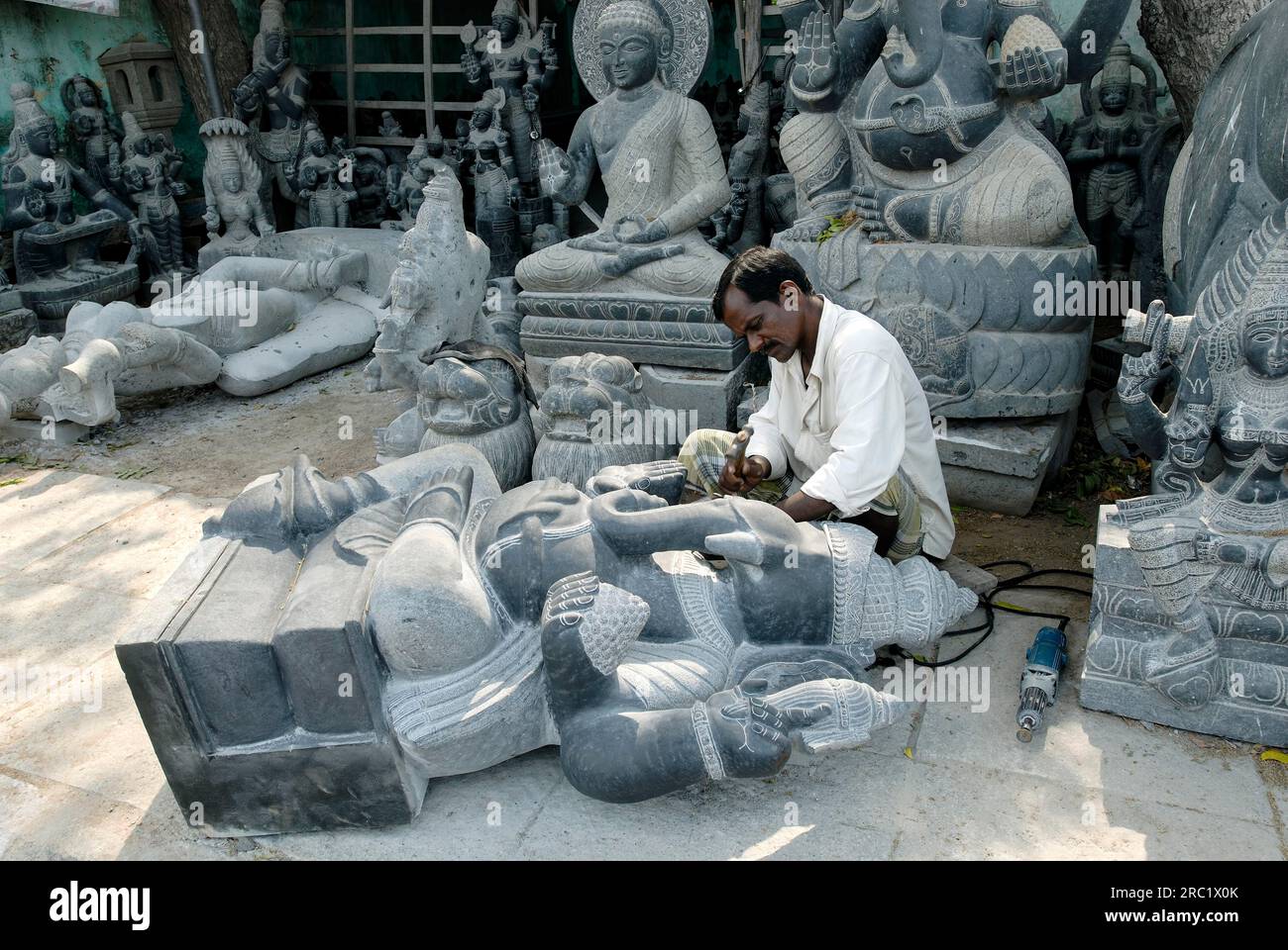 A sculptor at work carving a statue in Mahabalipuram Mamallapuram near