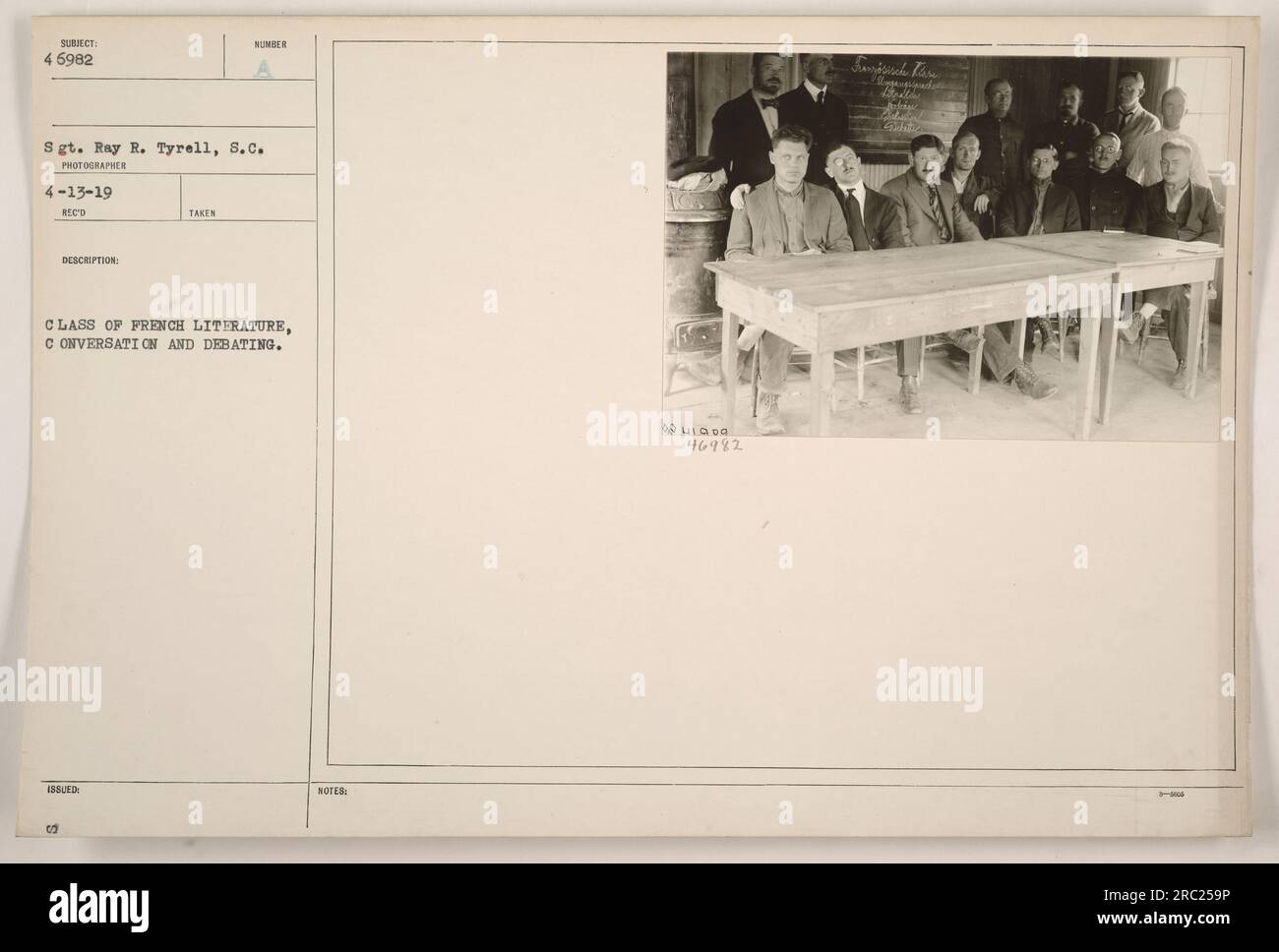 'Class of French literature engages in conversation and debating. Photograph taken by Sgt. Ray R. Tyrell, S.C. on April 13, 1919. Reference number: 6982. Notes: 41000, 46982, Smisisch there Alle Jokine.' Stock Photo