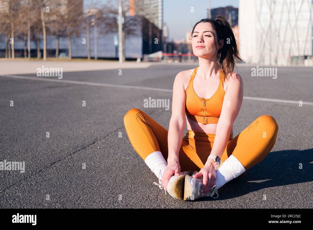 Woman athlete stretching legs hi-res stock photography and images - Alamy